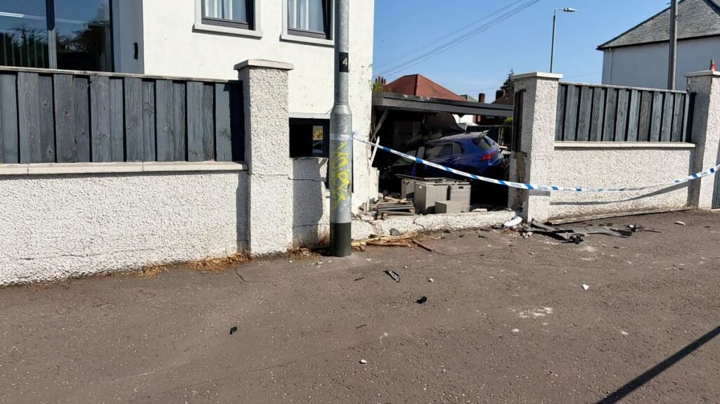 Man and woman arrested after car crashes into Belfast property